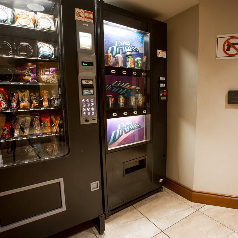 Vending machines with various snacks and drinks just outside the laundry facility