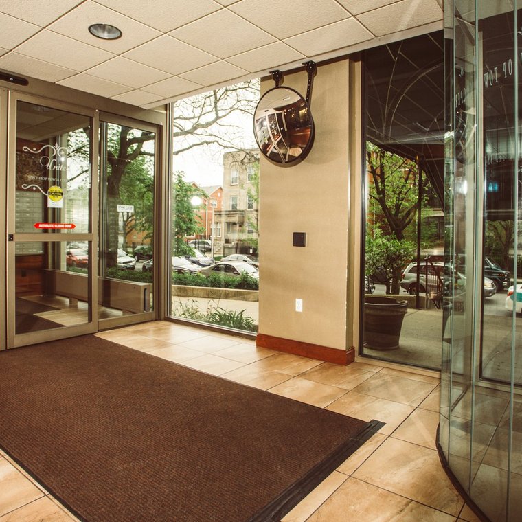 Lobby entrance interior with beige walls and floor with outside view of the street